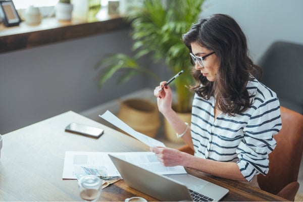 Customer reviewing written price offer for a new Ford vehicle