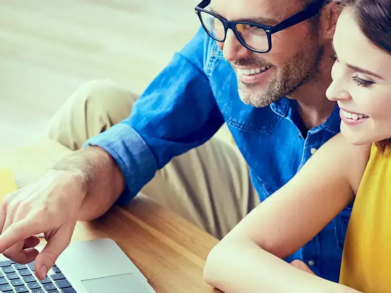 A man and woman sitting shopping online